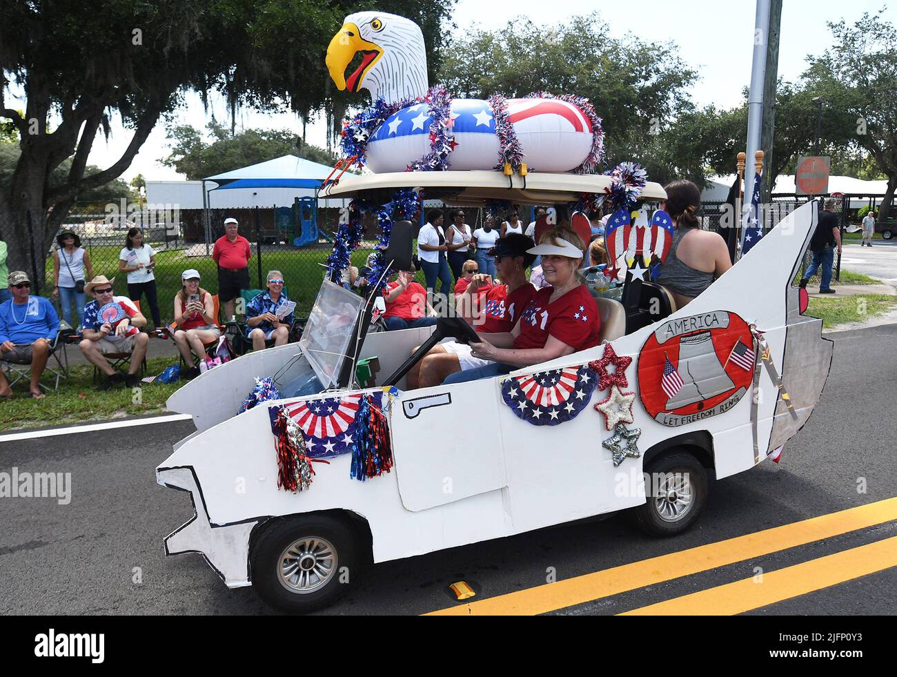 Geneva, United States. 04th July, 2022. People drive a decorated car in the  annual Fourth of July parade in Geneva. The yearly celebration included an  antique car show, a vintage aircraft flyover,