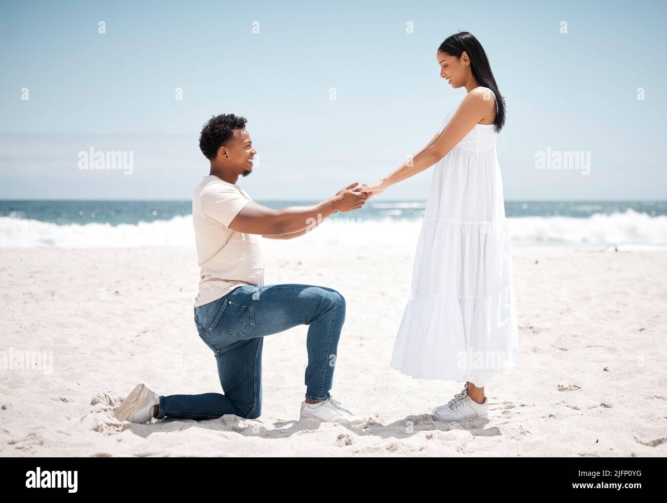 My always, my forever. Shot of a young man proposing to his girlfriend at the beach. Stock Photo