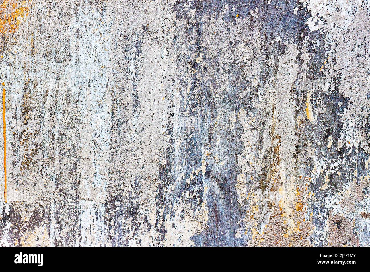 Old rough concrete peeling wall. Dirty damaged texture, peeling plaster, damaged wall. Vintage background Stock Photo