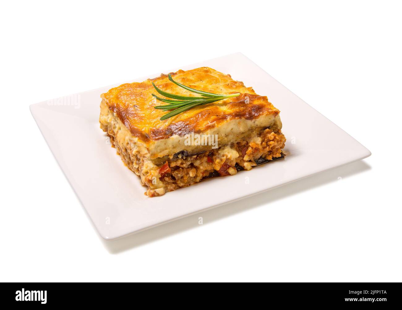 Greek Moussaka close up on a square plate isolated on white background. Stock Photo