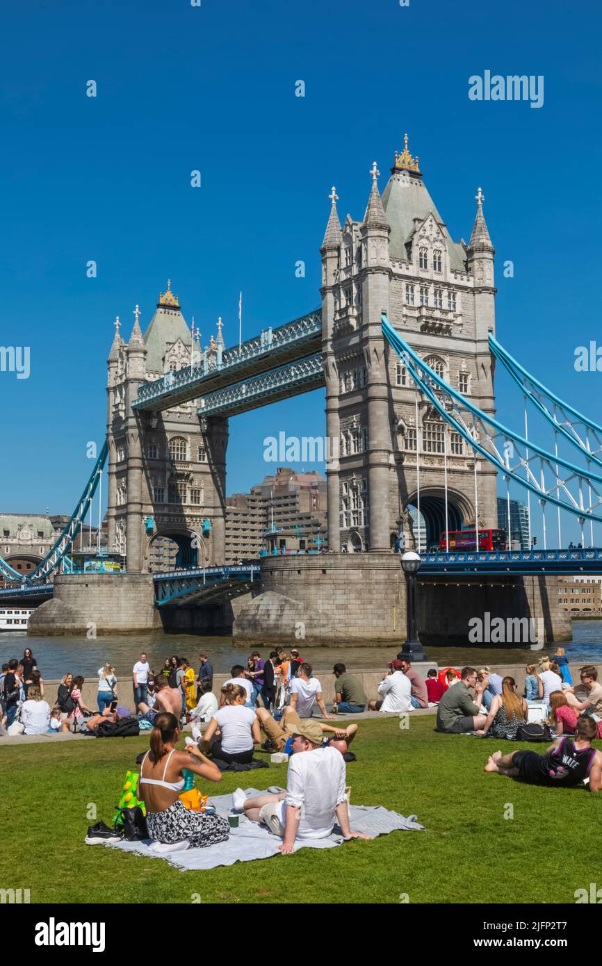Tower Bridge with People Relaxing on Grass in Foreground, London