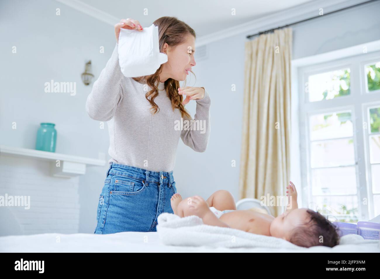 Mother changing toddler diapers hi res stock photography and