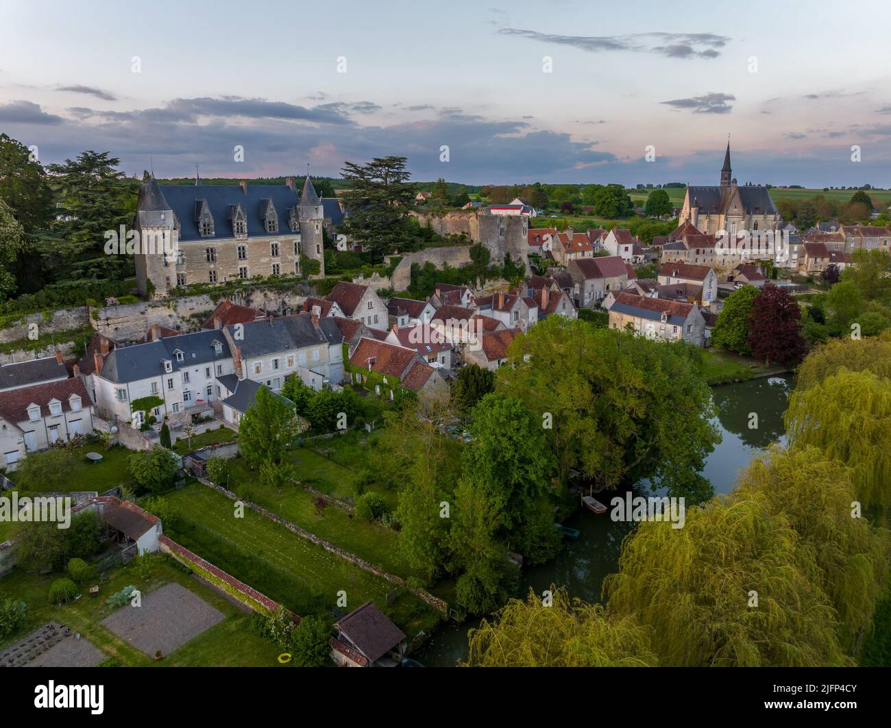Aerial sunset view of Montresor medieval castle with a Renaissance mansion in Indre et Loire, on a rocky overhand dominating the valley, on of the mos Stock Photo