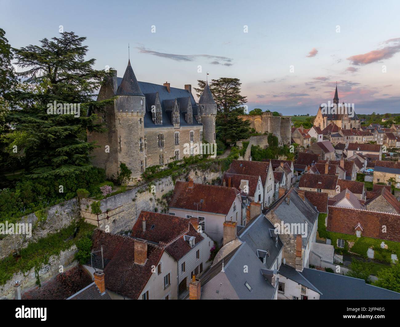 Aerial sunset view of Montresor medieval castle with a Renaissance mansion in Indre et Loire, on a rocky overhand dominating the valley, on of the mos Stock Photo