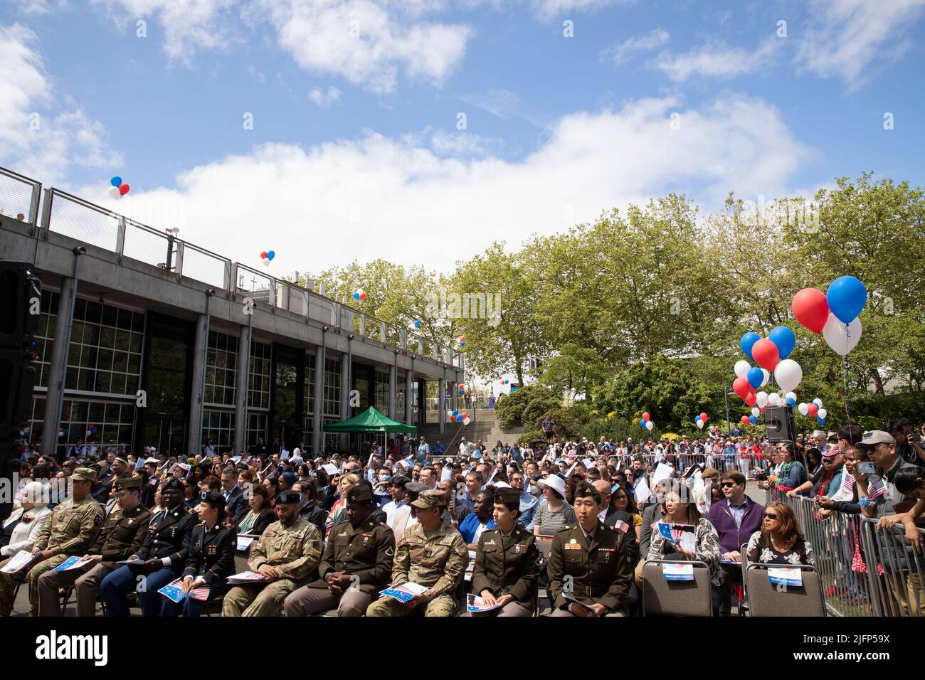 Seattle, Washington, USA. 4th July, 2022. Hundreds gather to witness a naturalization ceremony at Fisher Pavilion. The U.S. Citizenship and Immigration Services and U.S. District Court for the Western District of Washington partnered with Seattle Center to host the annual ceremony welcoming 300 applicants from 74 countries as new citizens. Credit: Paul Christian Gordon/Alamy Live News Stock Photo