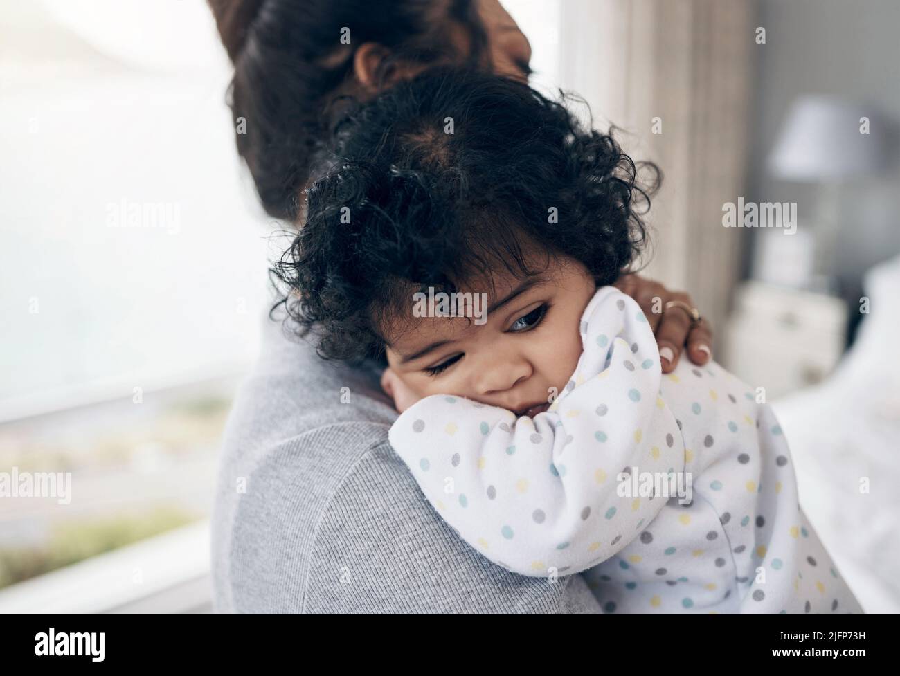 Is it nap time mama. Shot of a mother holding her baby daughter at home. Stock Photo