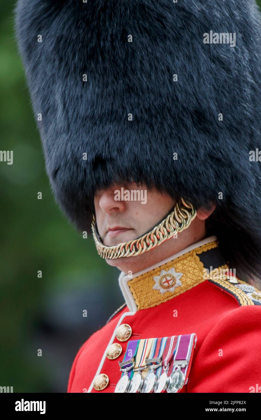 The Reason British Guards Wear Their Helmet Straps Under Their Lips Not