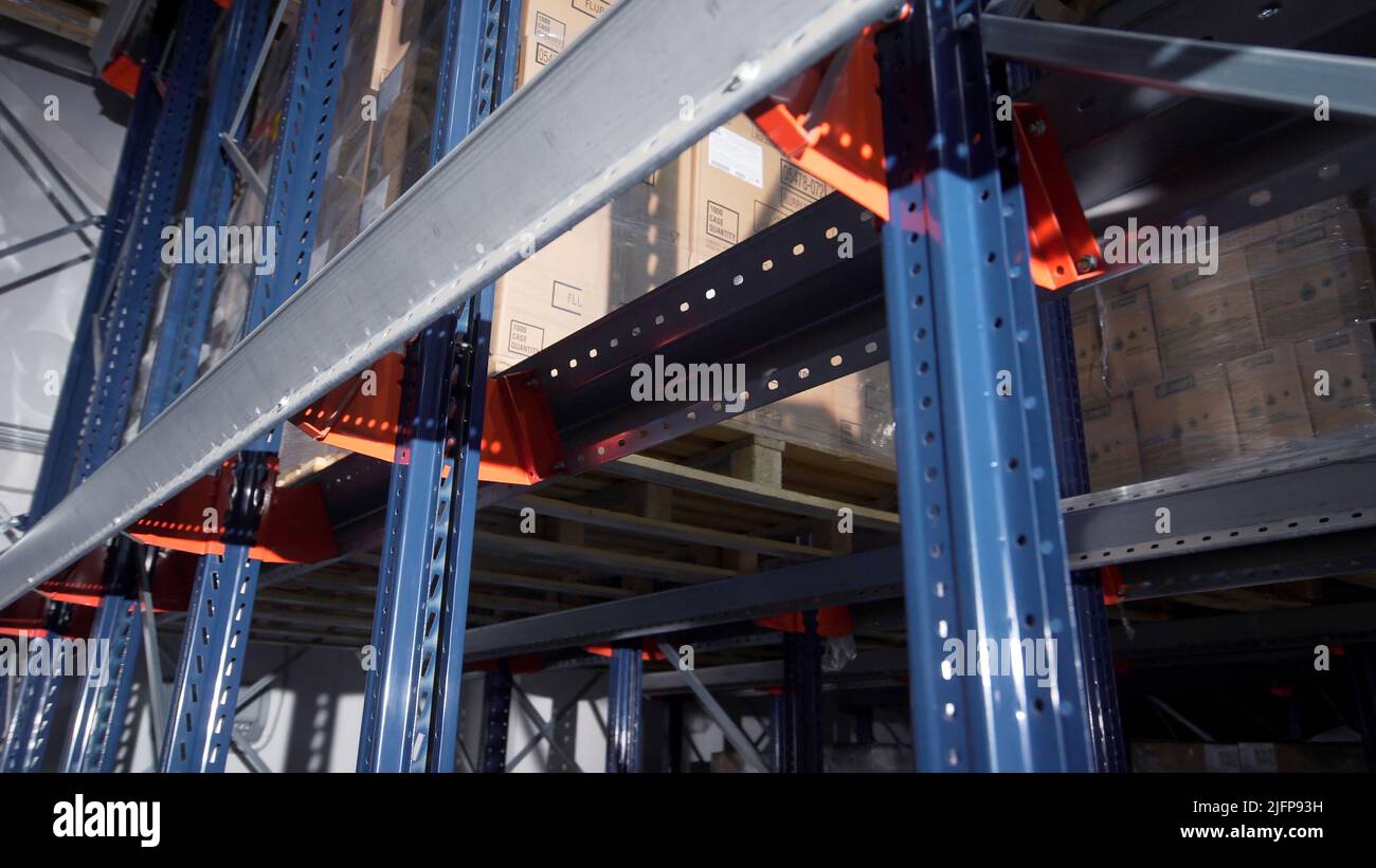 Shelves with boxes in warehouse. Creative. Closeup of iron structures