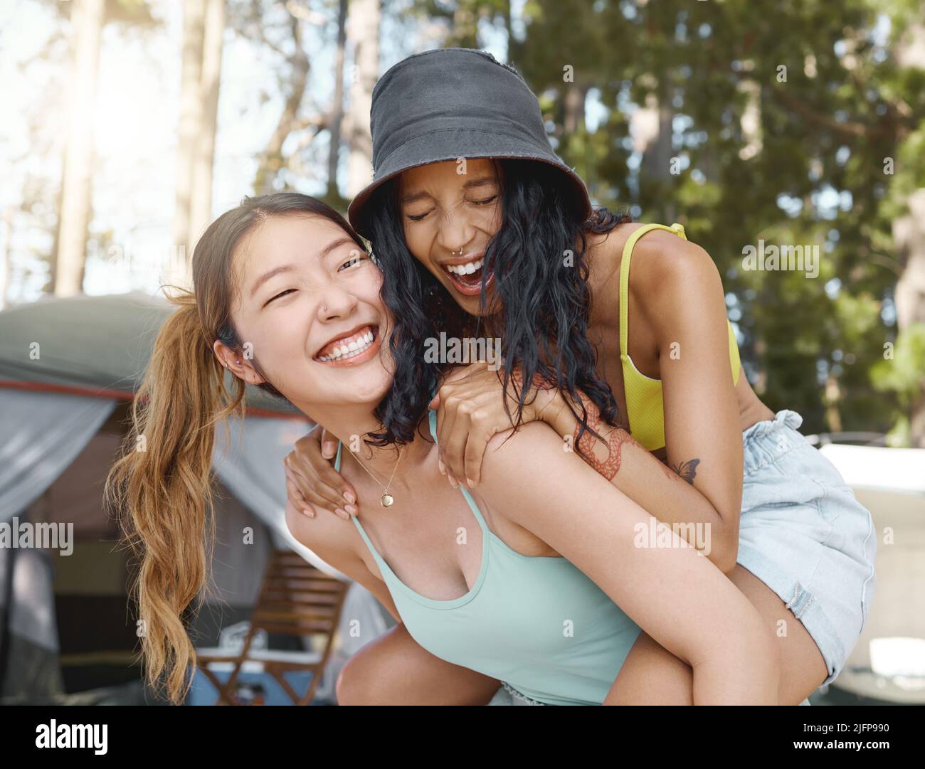 Black girl giving friend a piggyback ride Stock Photo - Alamy