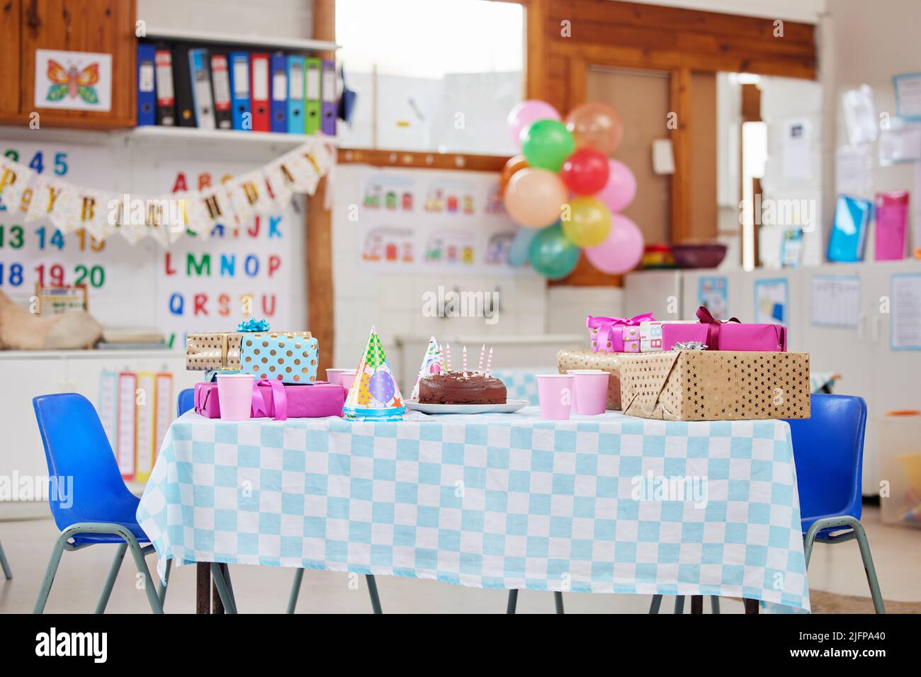 Its going to be a fun day in class. Shot of an empty class room decorated for a birthday party. Stock Photo