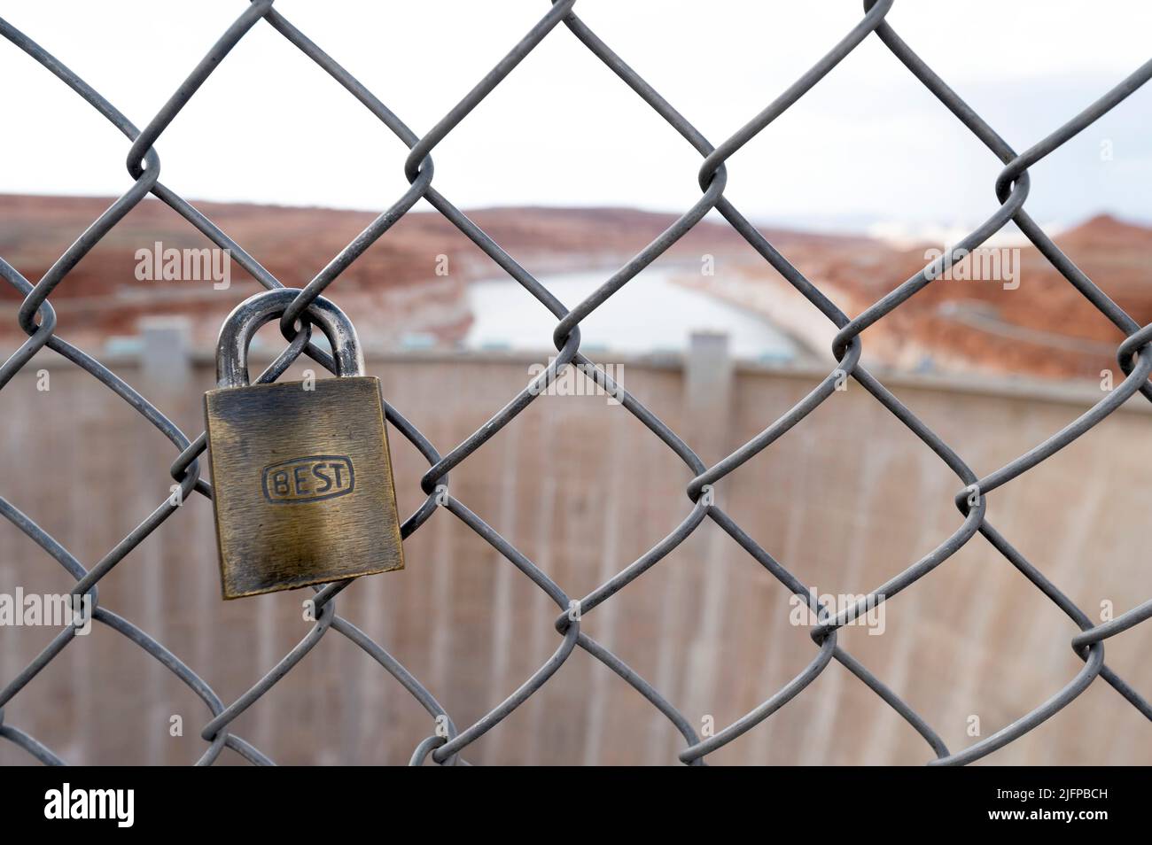 Page, Arizona, USA. 30th June, 2022. A padlock is attached to fencing near the Glen Canyon Dam at Lake Powell on June 30, 2022 in Page, Arizona. As severe drought grips parts of the Western United States, water levels at Lake Powell have dropped to their lowest level since the lake was created by damming the Colorado River in 1963. The Colorado River Basin connects Lake Powell and Lake Mead and supplies water to 40 million people in seven western states. (Credit Image: © David Becker/ZUMA Press Wire) Stock Photo