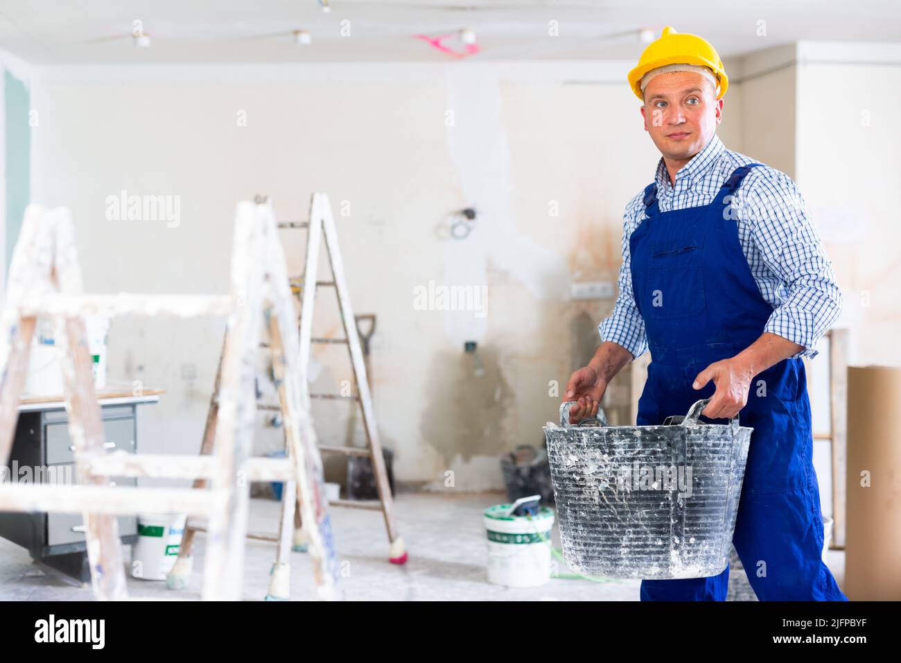 Man builder working in construction site Stock Photo - Alamy