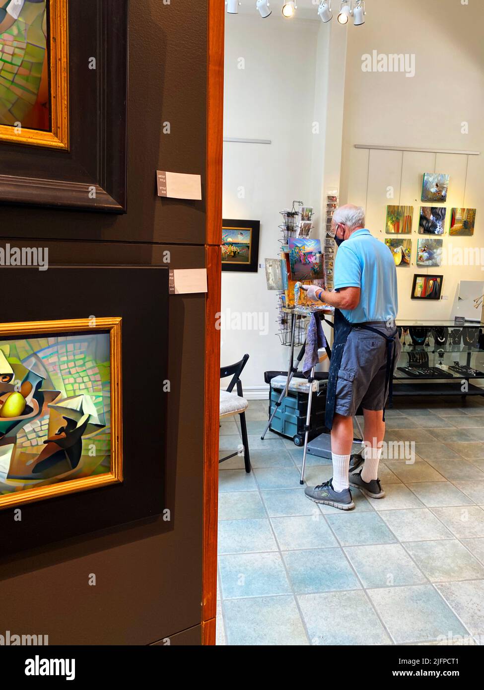 An artist painting in a gallery Stock Photo Alamy