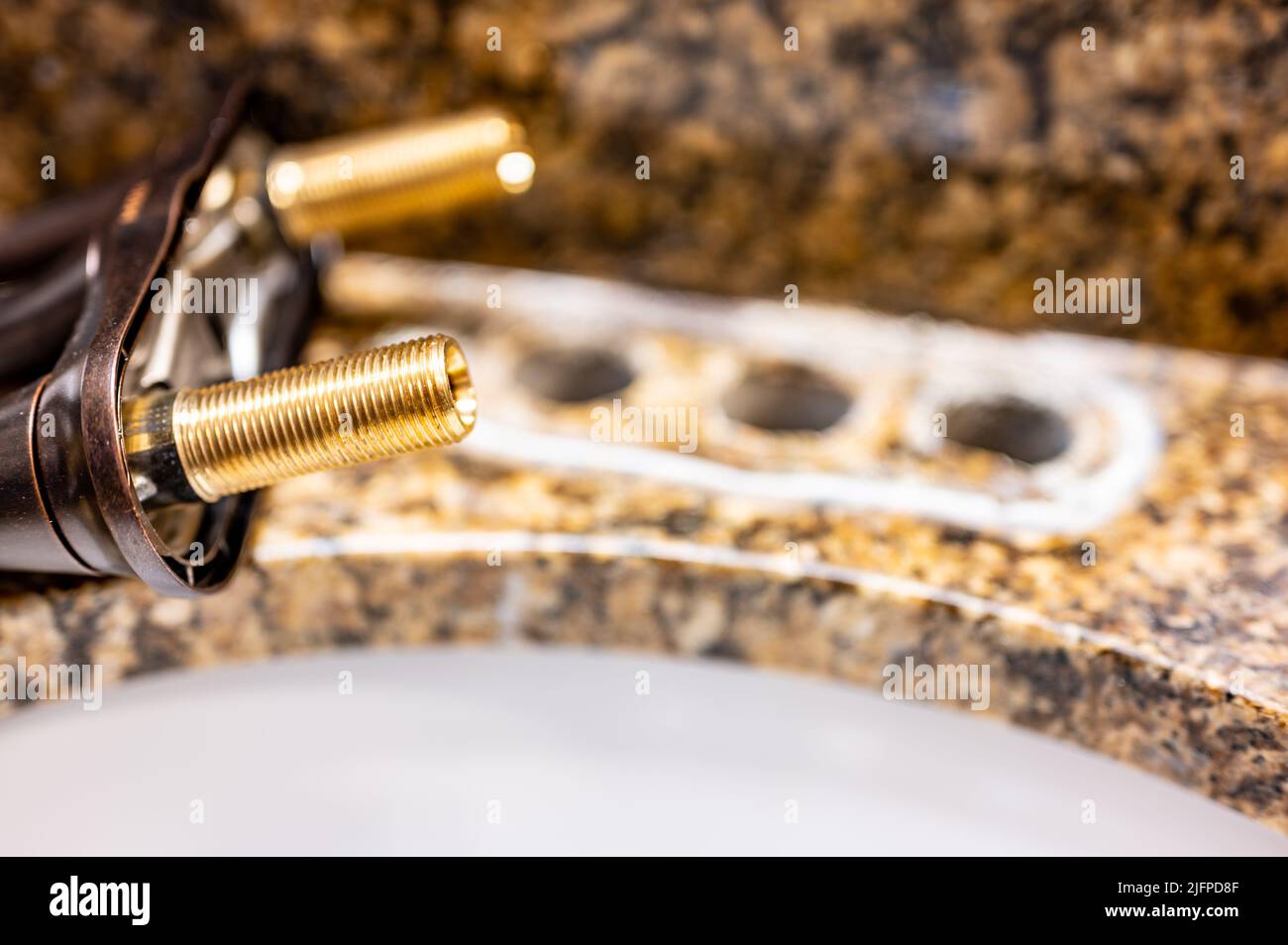 Replacing a bathroom sink faucet with a new assembly Stock Photo Alamy
