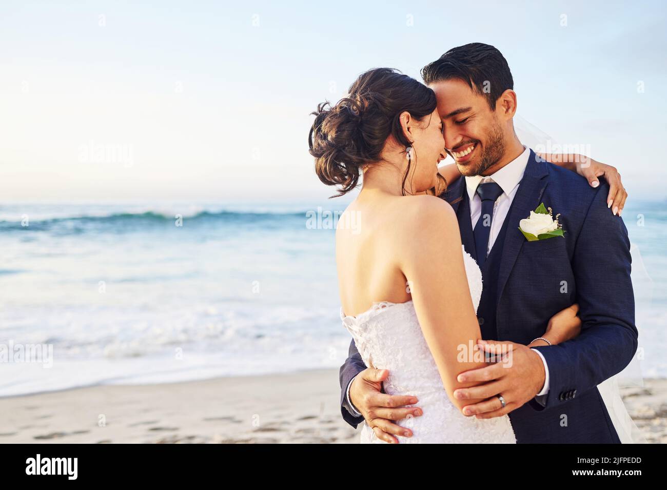 This is the best day of my life. Shot of a young couple on the beach on their wedding day. Stock Photo