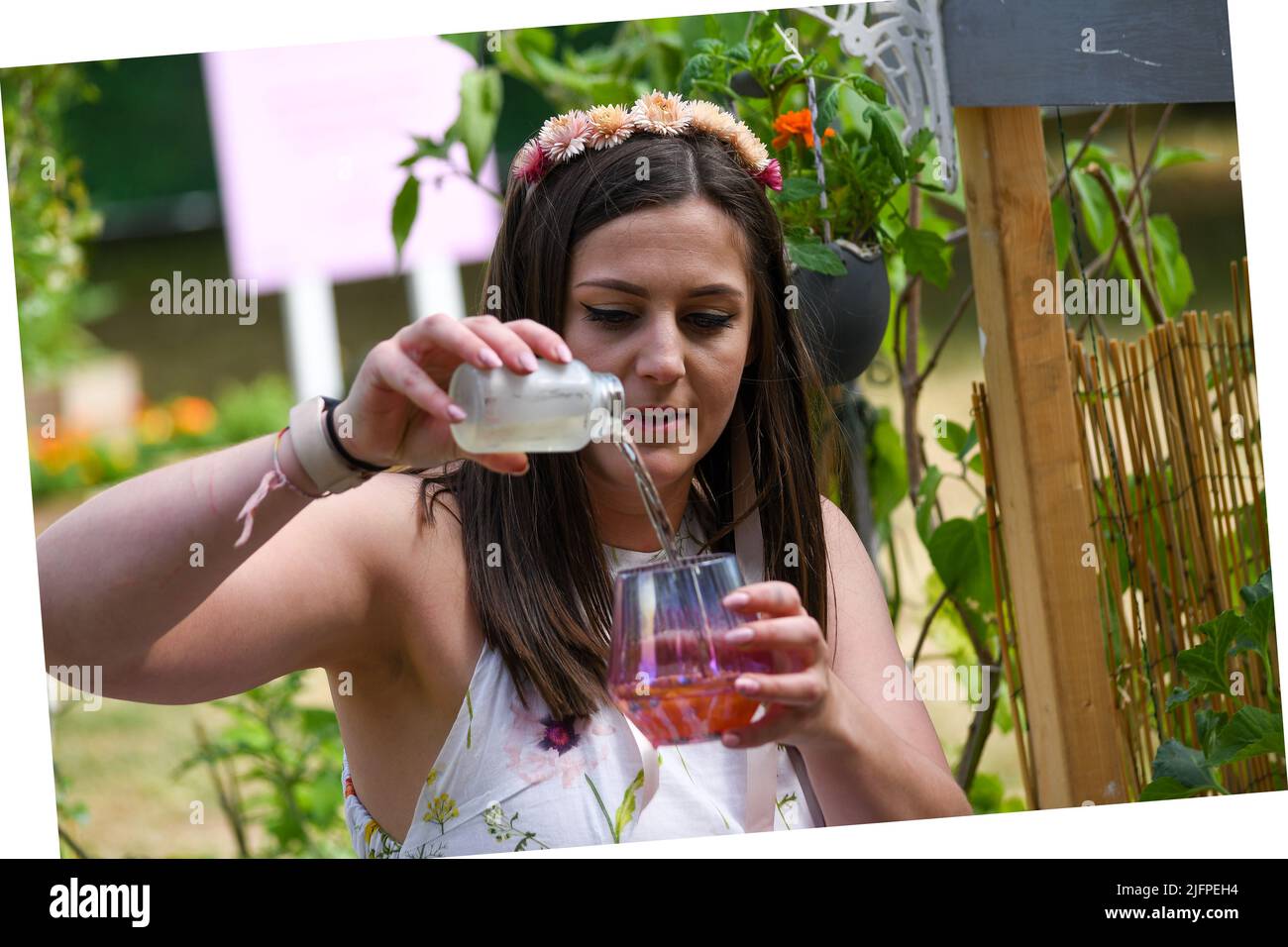 London, UK, 4th Jul 2022,  RHS Hampton Court Palace Garden Festival 2022 opens 4th to 9th July. It is a celebration of gardening packed with things to see and do. Shannon Keary head gardener of the Protect Our Playground shows how to make a cocktail from ingredients grown in the allotment to highlight the impact of litter on the environment., Andrew Lalchan Photography/Alamy Live News Stock Photo