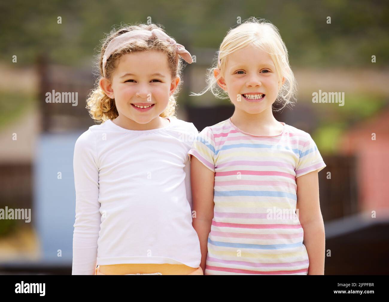 Image of Two girls standing funny poses - Austockphoto