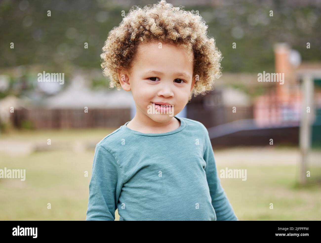 Lets play outside. Shot of an adorable little boy standing outside. Stock Photo