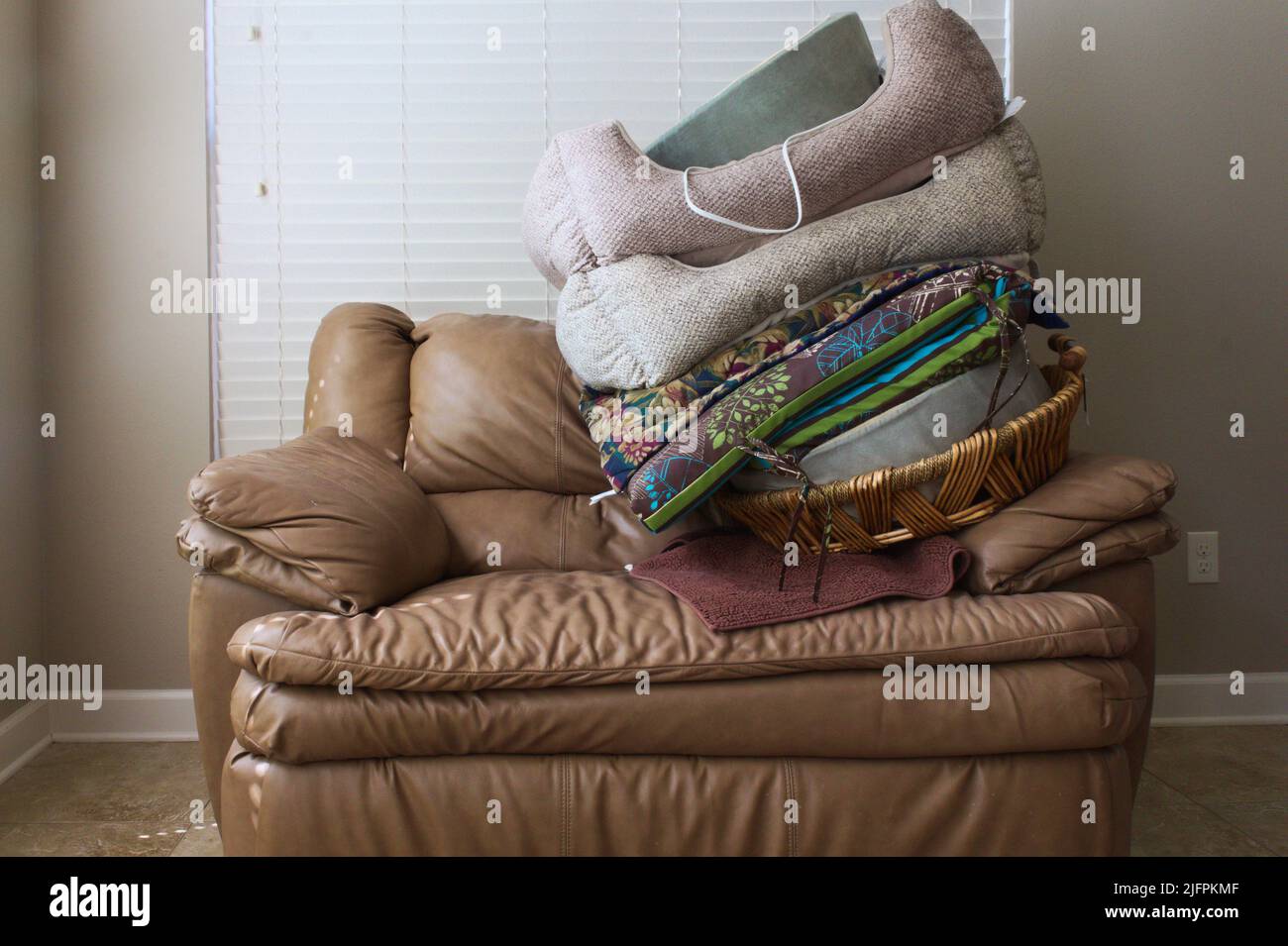 dogs beds stacked on chair and a half Stock Photo Alamy