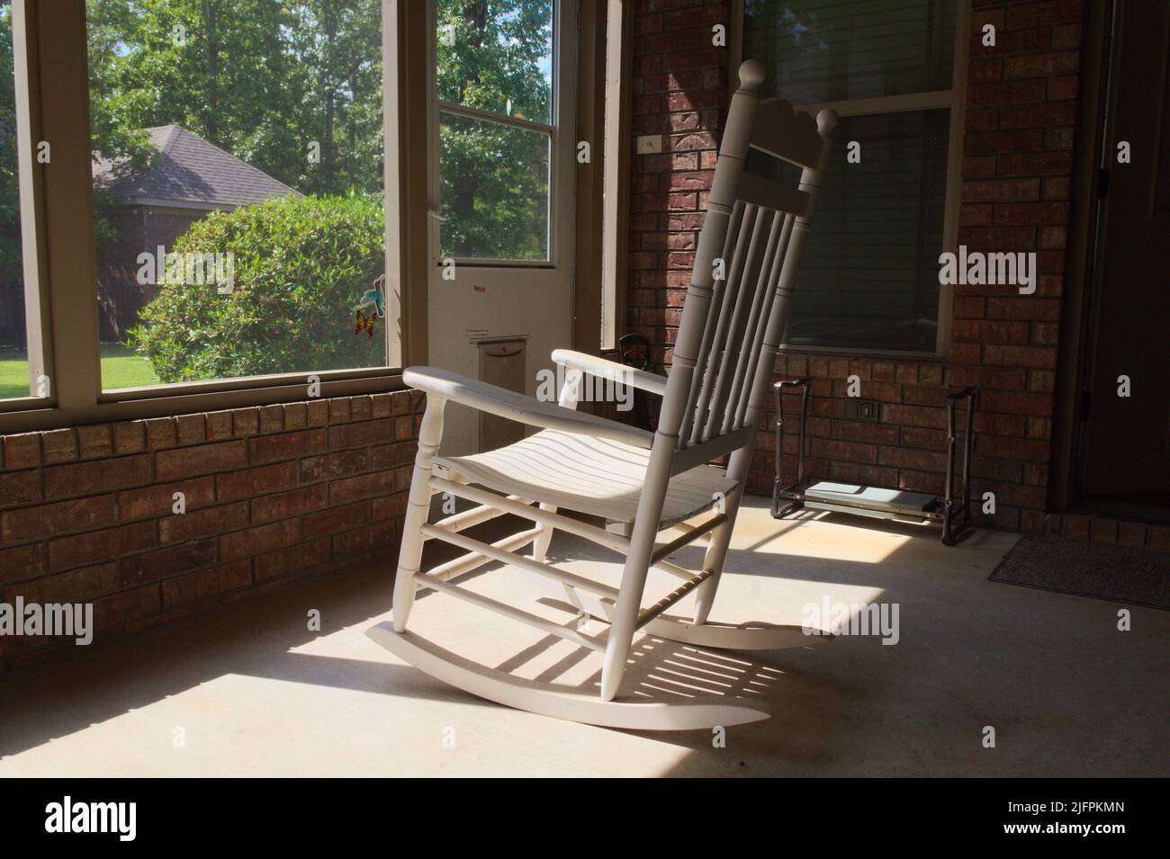 Old white rocking chair on screened porch Stock Photo Alamy