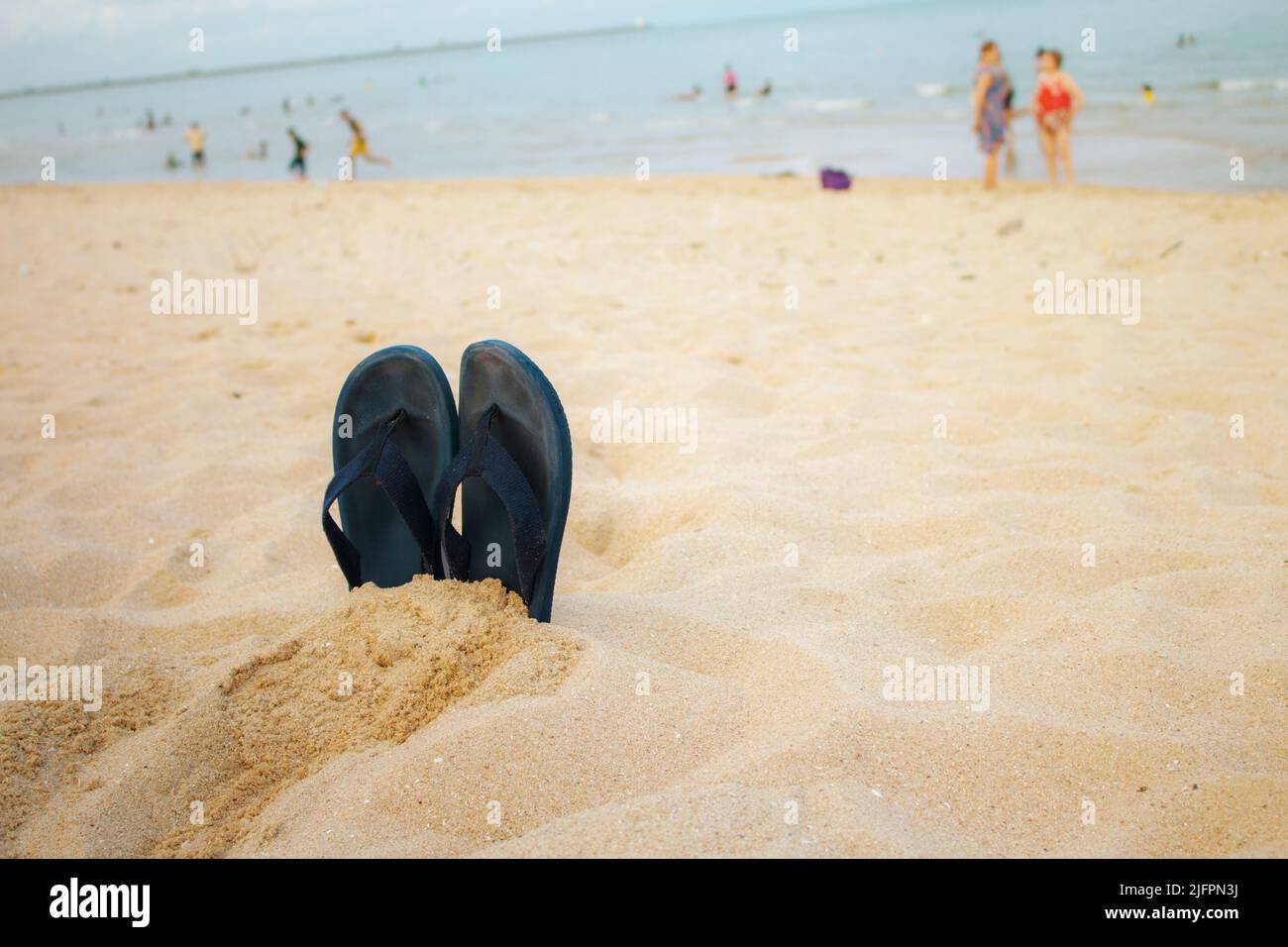 Sandals on beach at the sea Stock Photo - Alamy