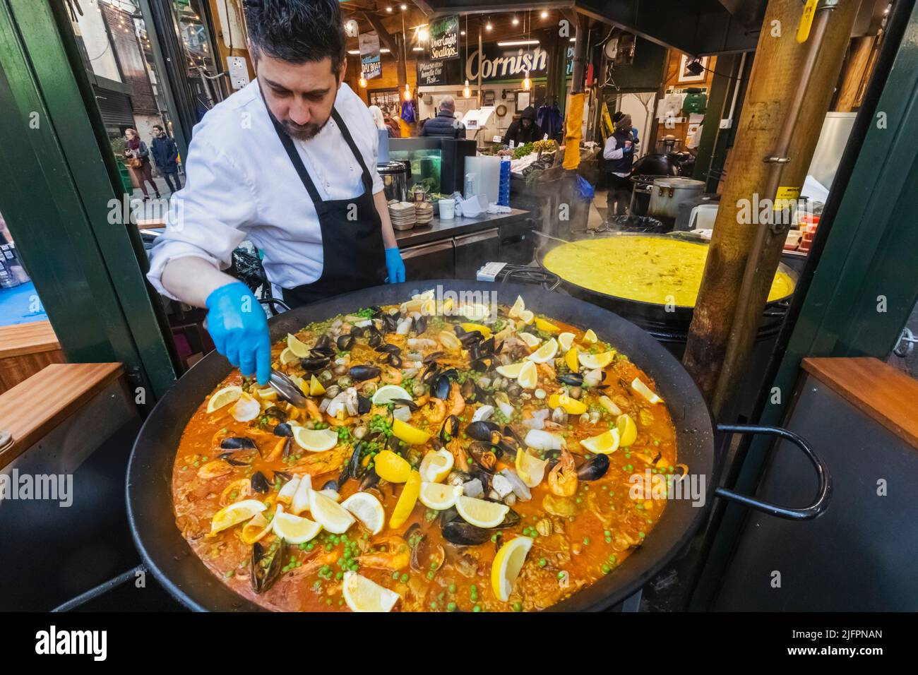 Borough Market, Man Cooking Giant Paella, Southwark, London, England ... Borough Market, Man Cooking Giant Paella, Southwark, London, England ...
