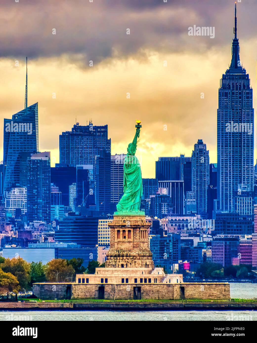 New york city skyline behind statue of liberty hi-res stock photography ...