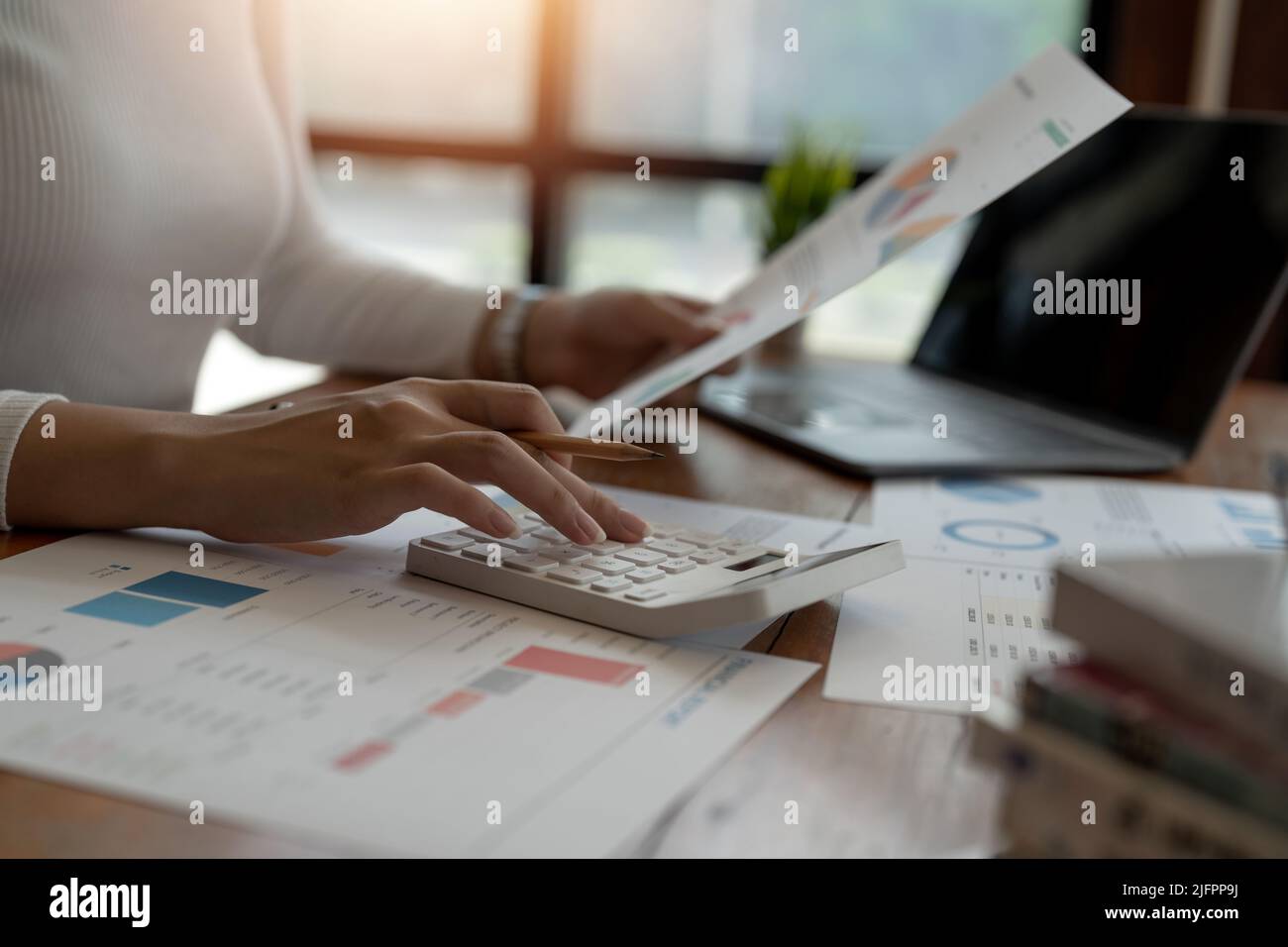 Businesswoman accountant or financial expert analyze business report graph and finance chart at corporate office. Concept of finance economy, banking Stock Photo