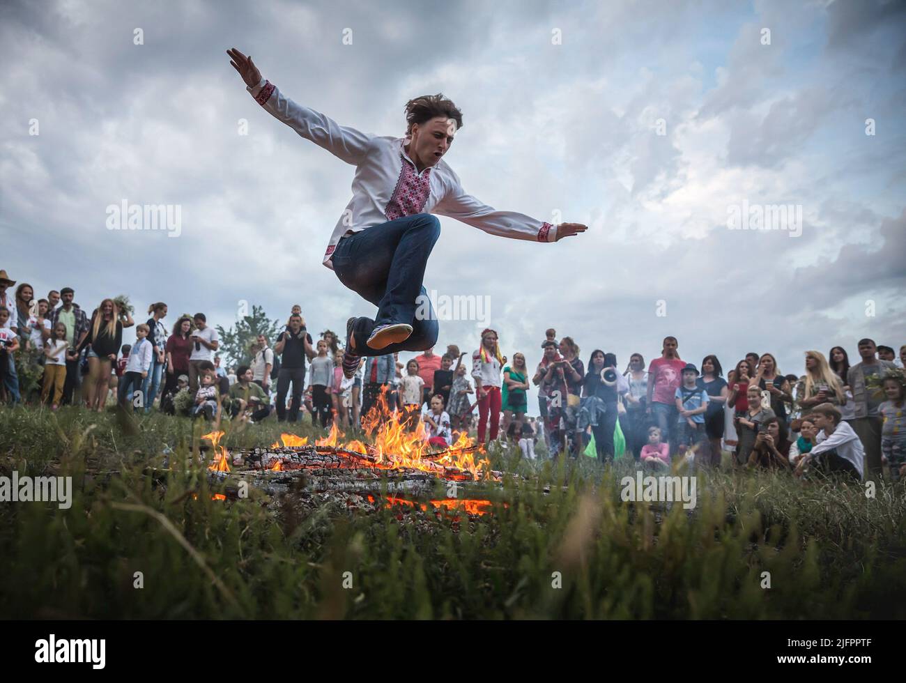 A man jumps over the flames of a bonfire during a ritual test of bravery and faith. This holiday symbolizes the birth of the summer sun – Kupalo. The history of the Christian Church can answer us how the pagan deity Kupalo gets the name of Ivan. In the IV century AD, this day was proclaimed the holiday of the birth of John the Baptist - the forerunner of Jesus Christ. As a result of the Christianization of the pagan feast the name 'Kupala' got connected with the Christian 'Ivan'. On the territory of Ukraine for many centuries Kupala customs changed, there were always local differences, and the Stock Photo