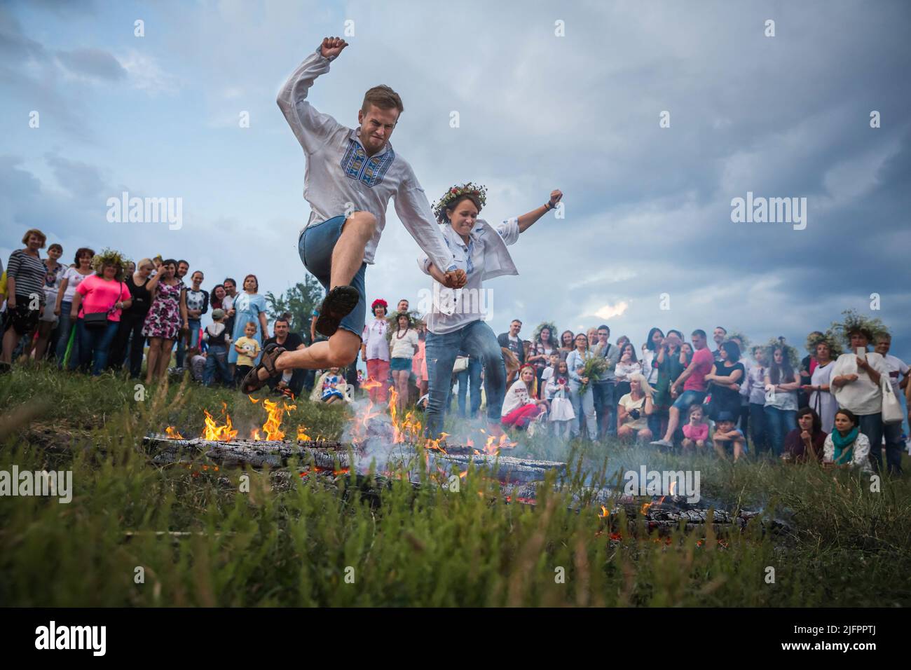 People jump over the flames of a bonfire during a ritual test of bravery and faith. This holiday symbolizes the birth of the summer sun – Kupalo. The history of the Christian Church can answer us how the pagan deity Kupalo gets the name of Ivan. In the IV century AD, this day was proclaimed the holiday of the birth of John the Baptist - the forerunner of Jesus Christ. As a result of the Christianization of the pagan feast the name 'Kupala' got connected with the Christian 'Ivan'. On the territory of Ukraine for many centuries Kupala customs changed, there were always local differences, and the Stock Photo