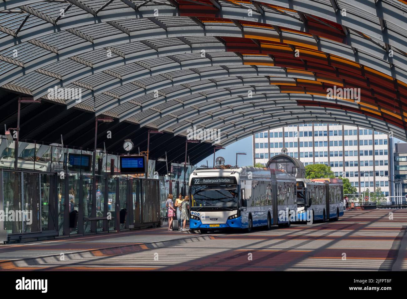 Amsterdam, The Netherlands - 21 June 2022: People boarding a GVB Bus at Amsterdam Central Station Bus Station Stock Photo