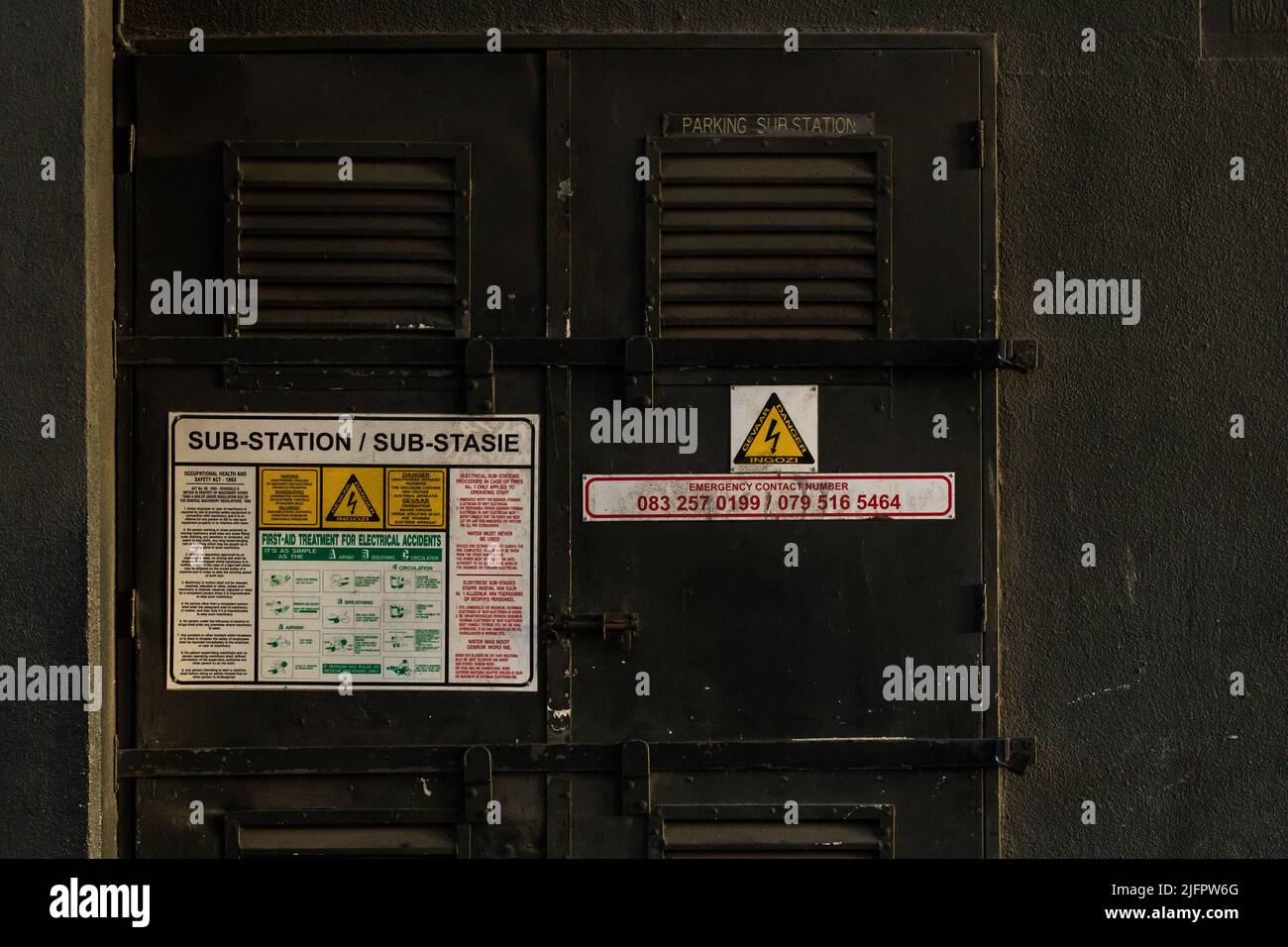 electricity substation or sub station door showing first aid directions and information for emergency use as well as danger sign or signage, Cape Town Stock Photo