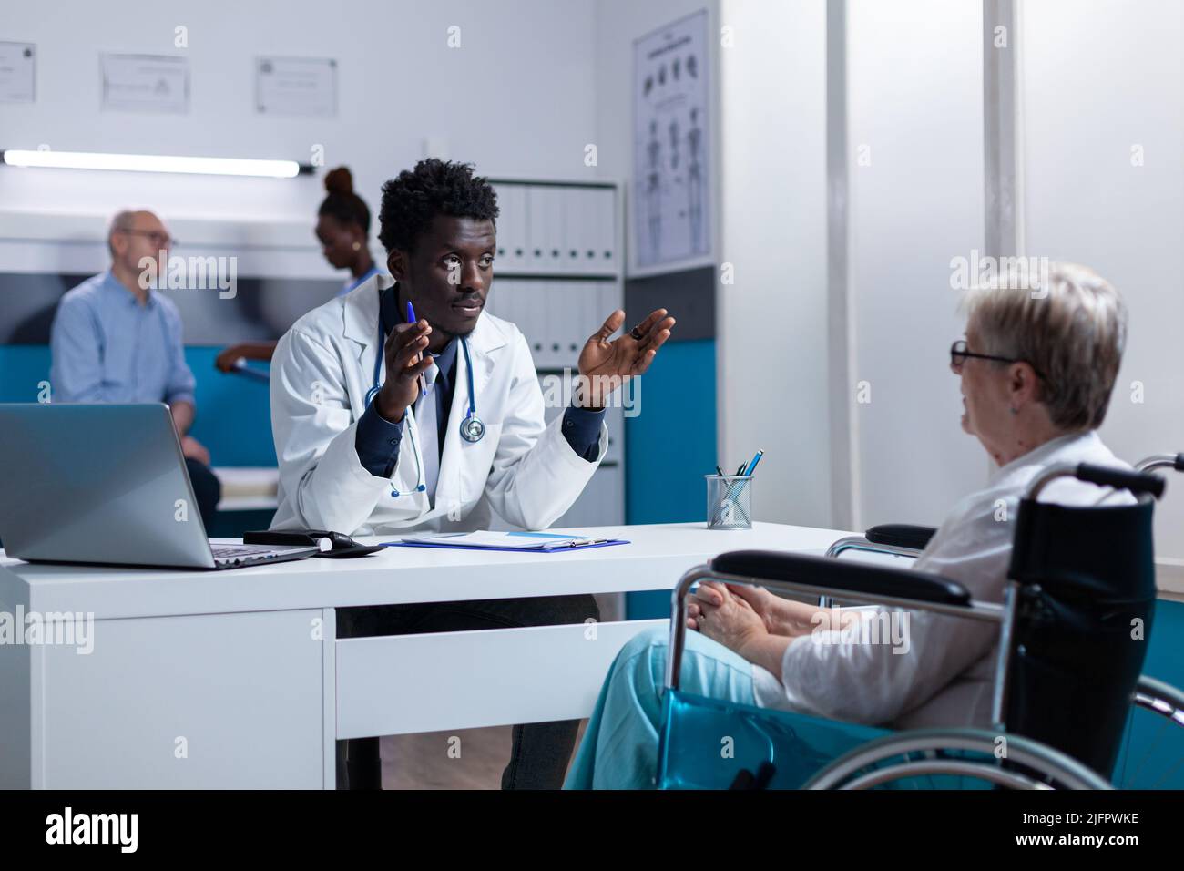 Physician expert explaining noninvasive procedure and treatment schedule to senior patient in