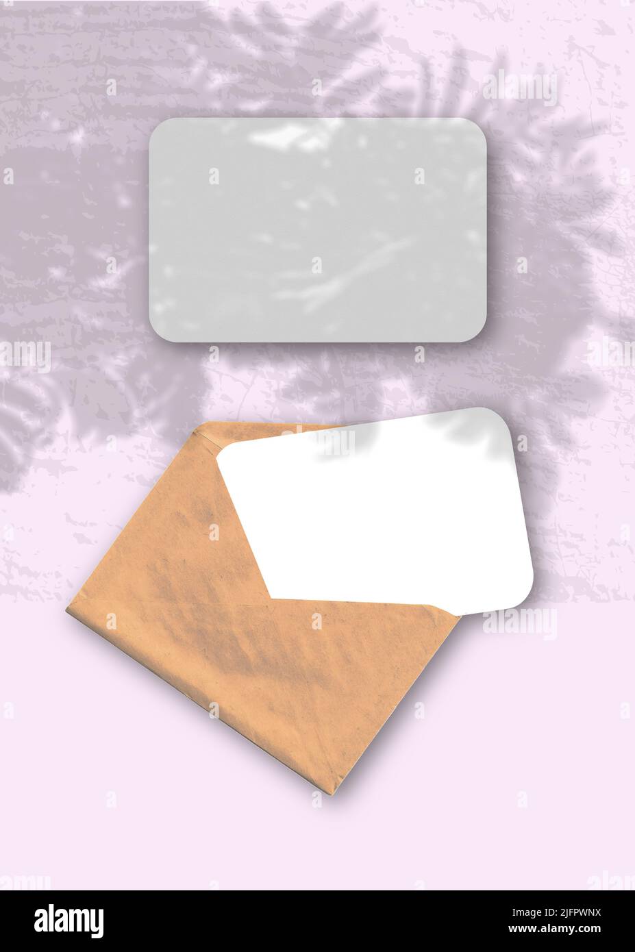 An envelope with two sheets of textured white paper on the pink