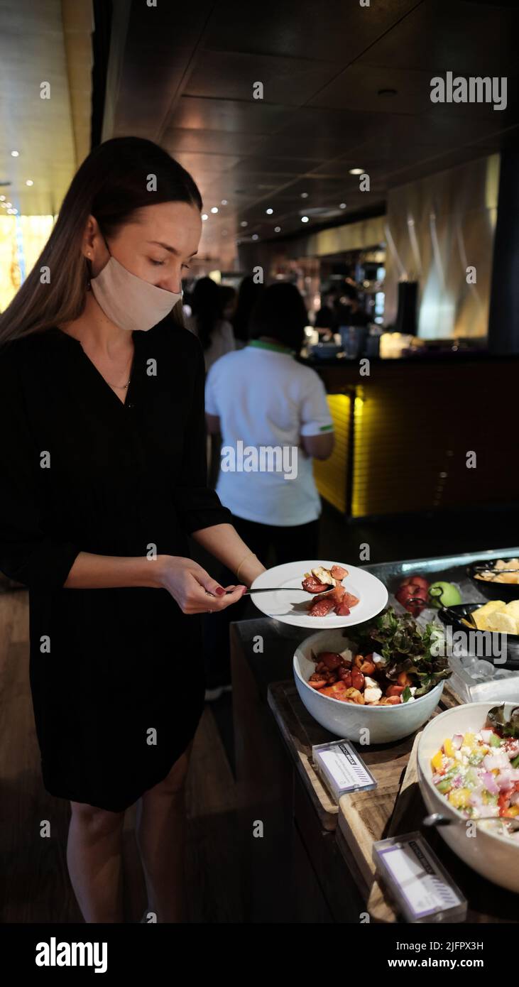 Female Foodie at Buffet Serving Line W Hotel Kitchen Table Restaurant Bangkok Thailand Stock Photo