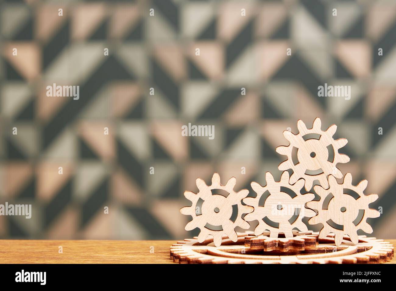 Mechanism with a heap of wooden gears connected on the table. Teamwork and complex systems