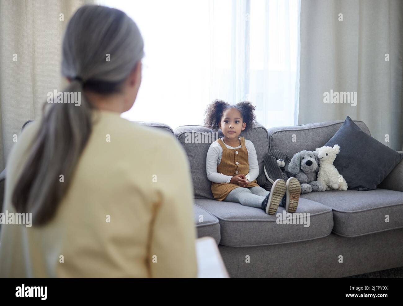 You can feel safe here. Shot of a therapist speaking to her young