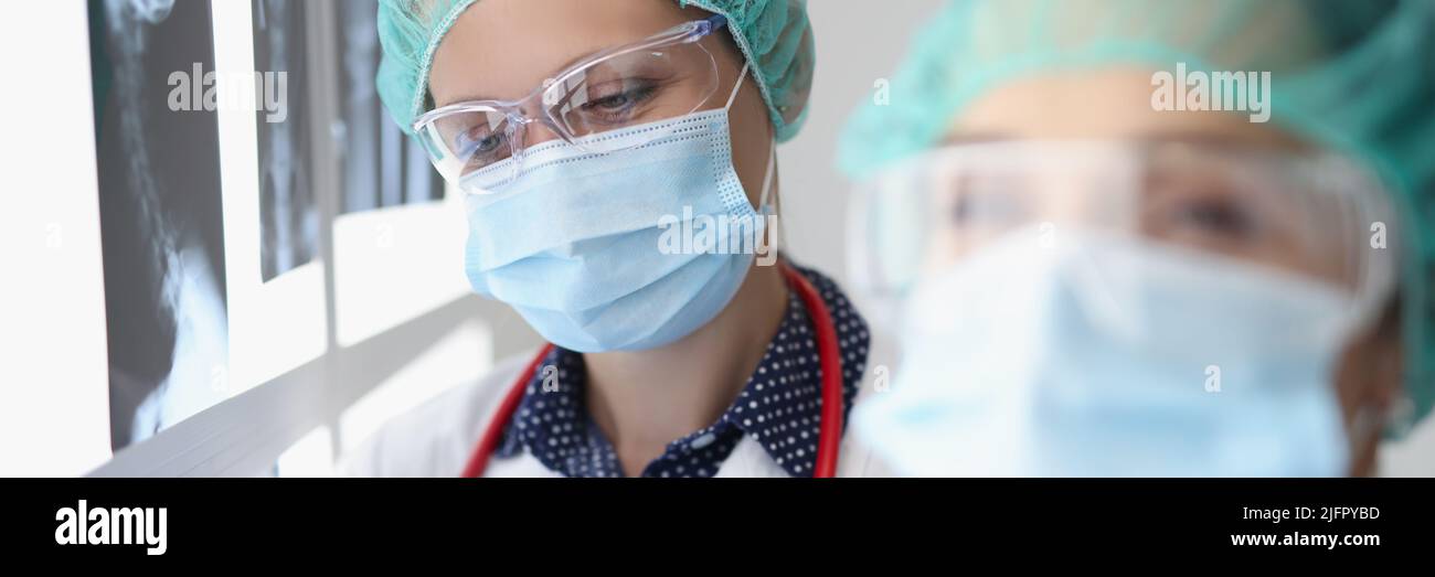 Women professional doctor look through x ray scans in hospital Stock Photo