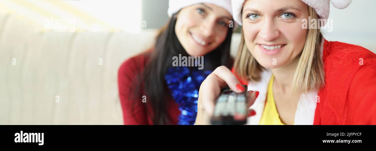 Friends holding remote control and switch to next year Stock Photo