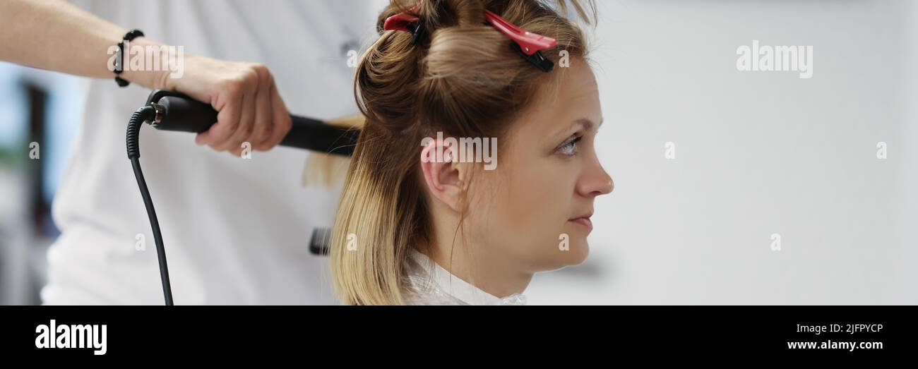 Blonde woman on planned hairdresser appointment enjoy new image in mirror Stock Photo