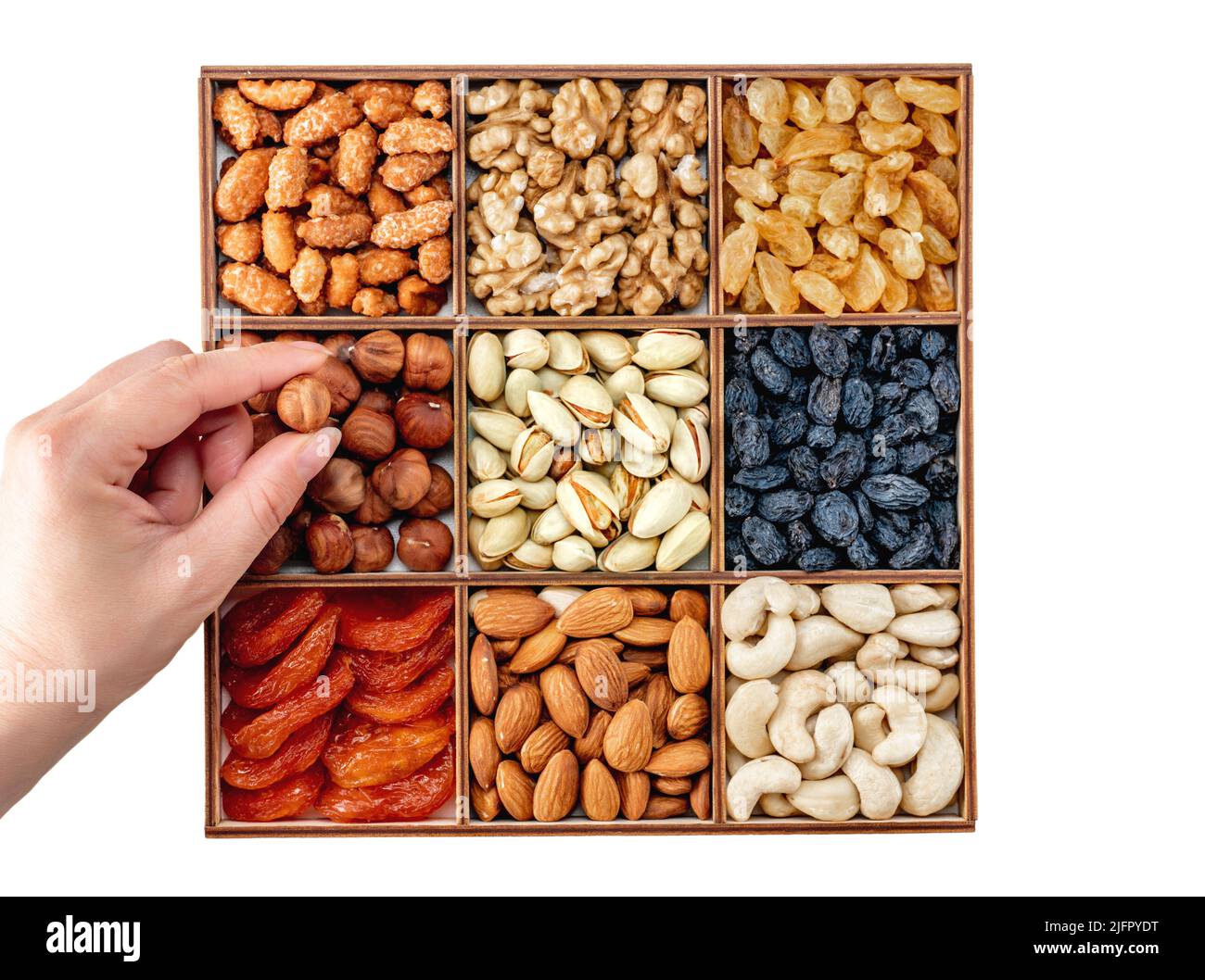 Hand with assorted nuts and dried fruit collection. Assorted nuts almonds, pistachio, cashews, walnut. Organic mixed nuts background. Healthy food, Us Stock Photo