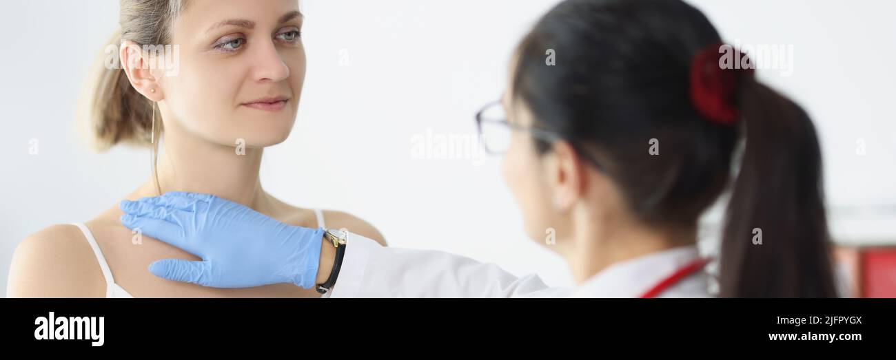 Blonde female on doctors appointment being examined by professional medical worker Stock Photo