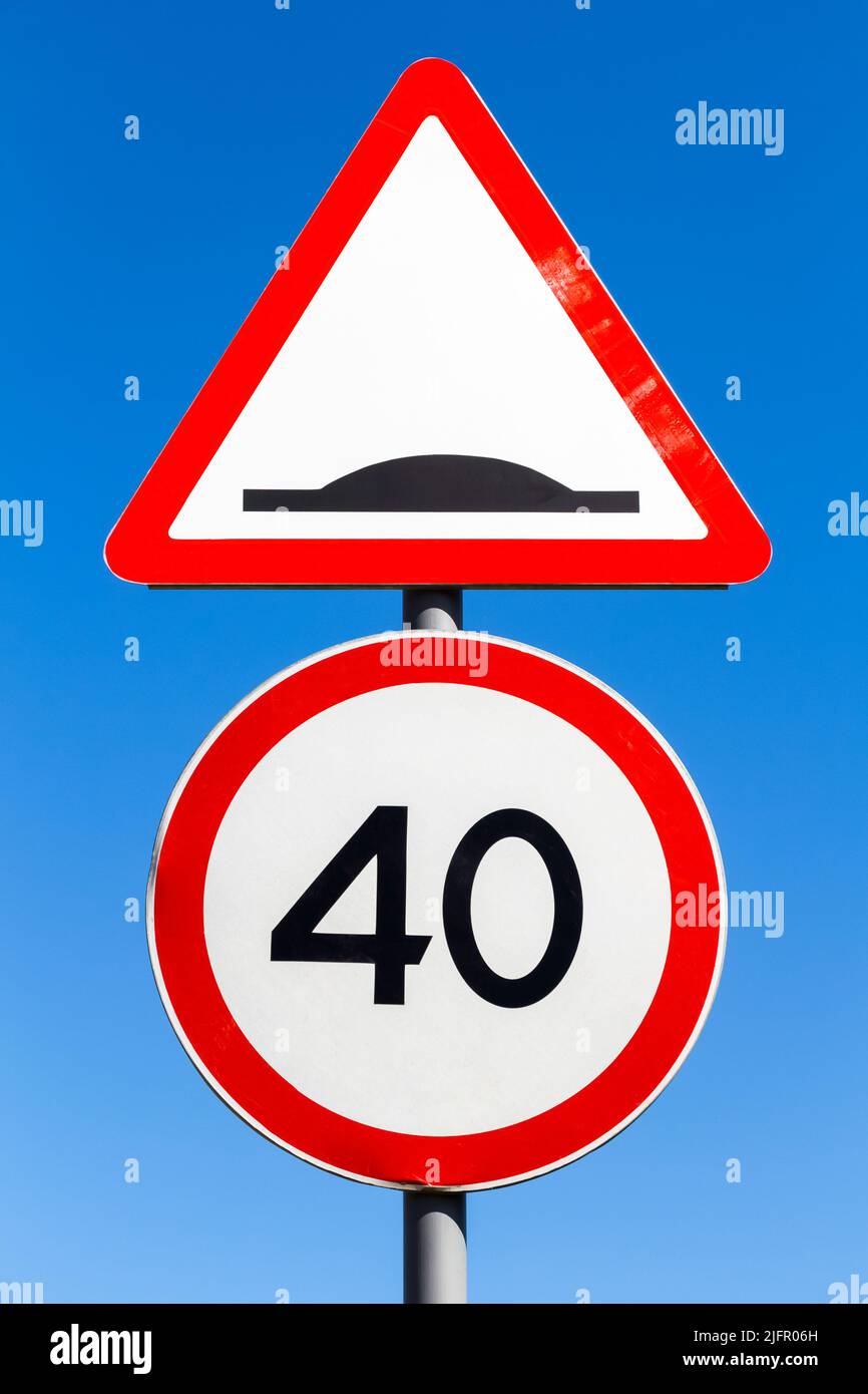 Two traffic signs on one post. Speed limit and rough road. Stock Photo