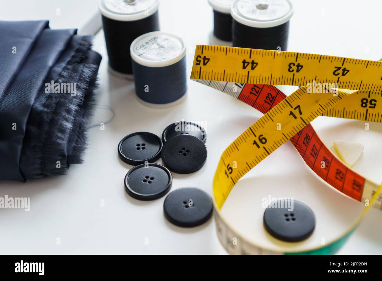 Sewing items and seamstress tools. Tailoring measuring tape, rulers, pins,  buttons, fabric Stock Photo - Alamy