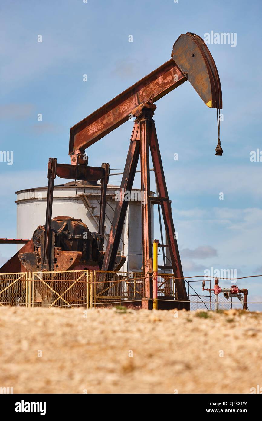 Oil pumping machine and fuel tank. Petroleum extraction. Resource Stock Photo