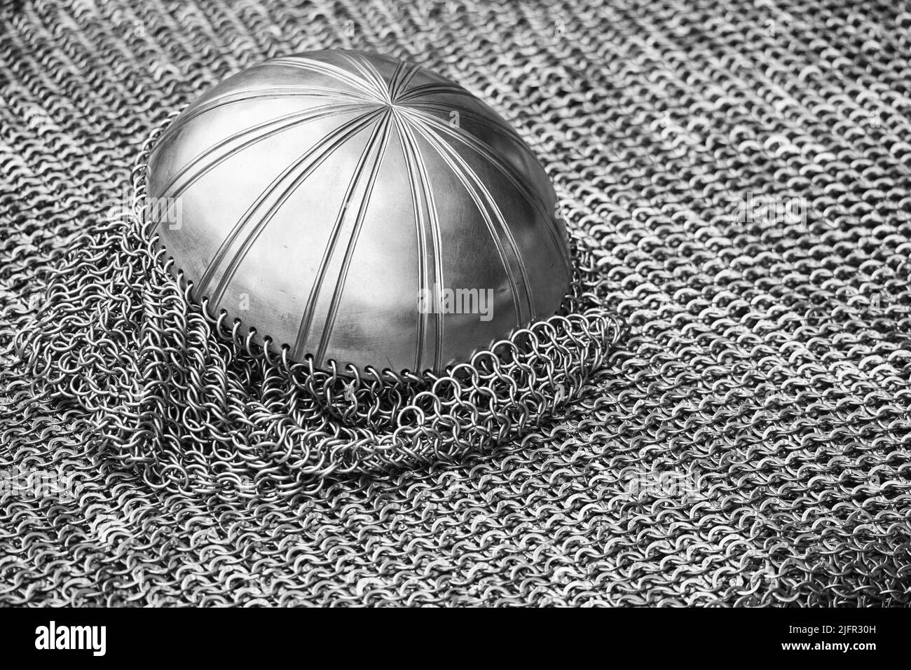 Vintage armor, retro chain mail and a protective metal helmet. Ancient military arsenal of the events of the Russian-Swedish war Stock Photo