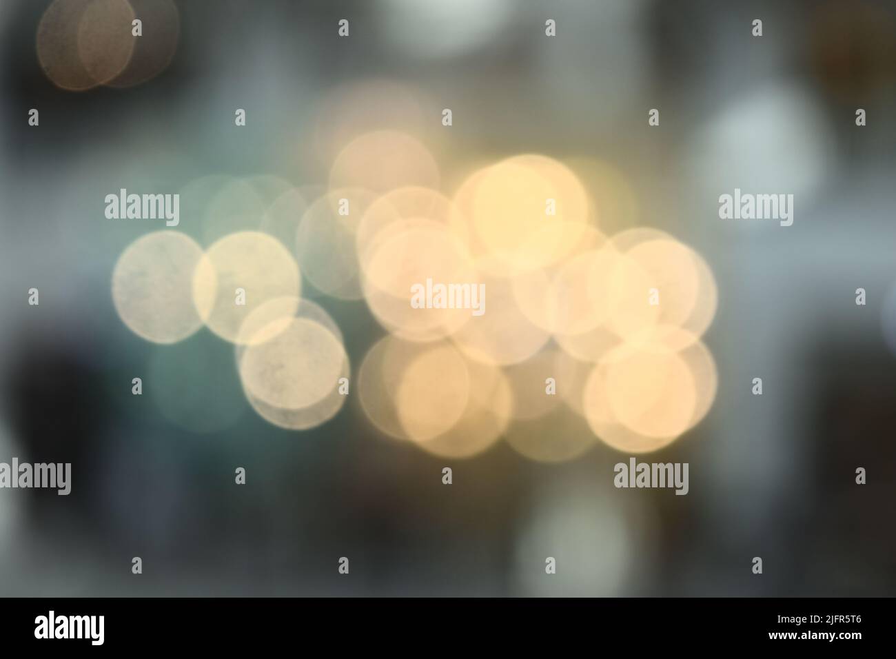 Bokeh from indoor lighting,  Colorful light circles spread on blue with yellow and green background for the celebration of the holiday season Stock Photo