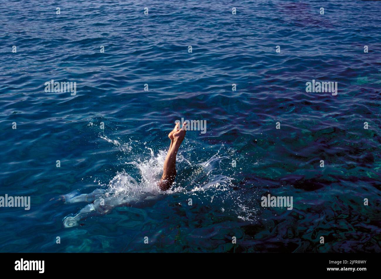 woman jumping on seawater just 2 feet appear above surface Stock Photo
