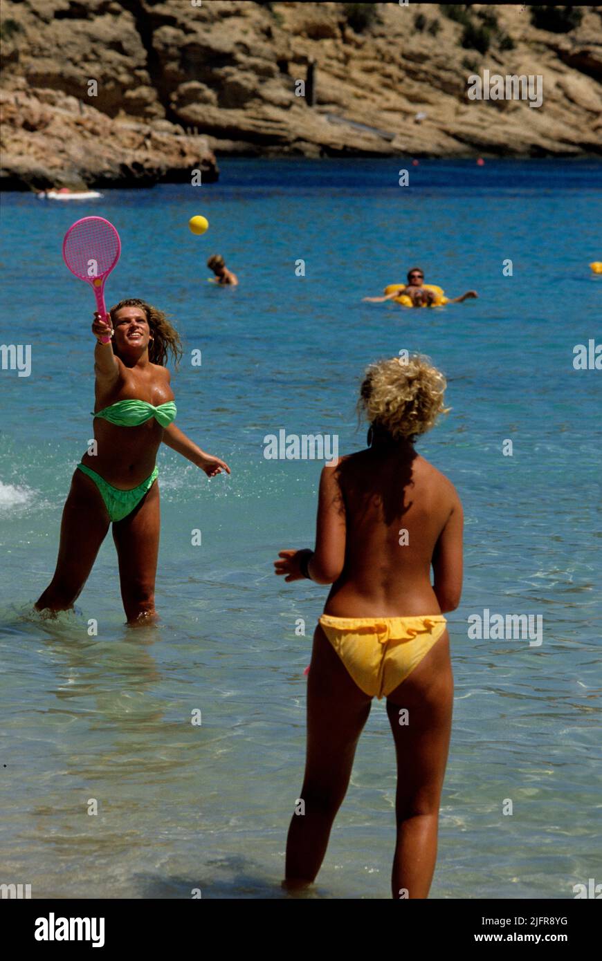 2 pretty blond girls palying beach ball Stock Photo