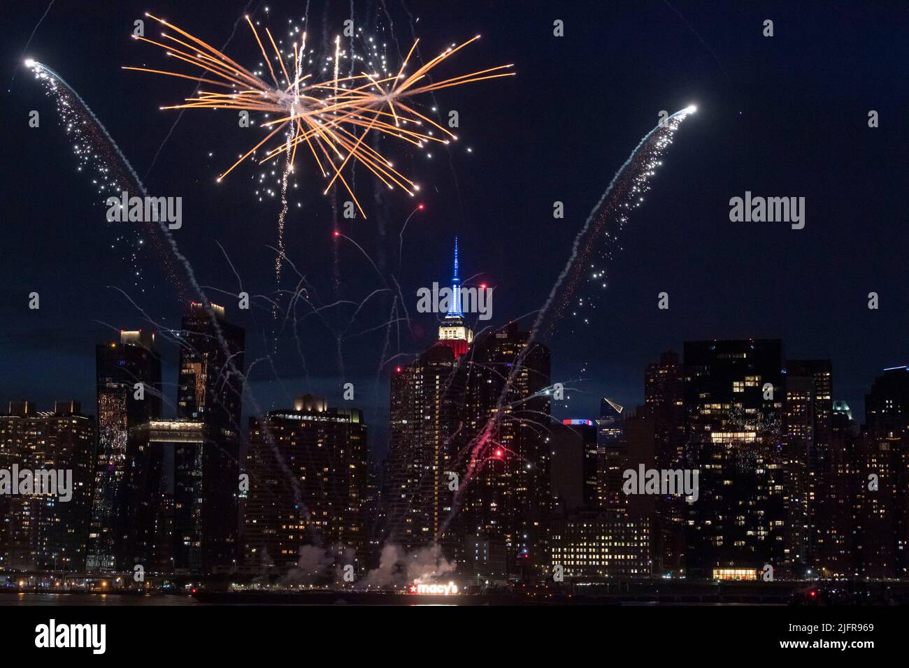 NEW YORK, NY - JULY 04: Fireworks explode over the east river during ...